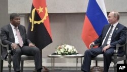 FILE - Angola's President Joao Lourenco, left, speaks to Russia's President Vladimir Putin at the BRICS summit in Johannesburg, South Africa, July 26, 2018. 