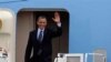 President Barack Obama waves upon arrival to Cartagena, Colombia, April 13, 2012.