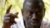 FILE - Opposition leader Kizza Besigye speaks during a news conference at his home at the outskirts of Kampala, Uganda, Feb. 21, 2016. His lawyer says the latest charges against his client are "just harassment."
