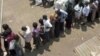 FILE – Voters line up at a polling station in Kampala, Uganda, in February 2011, as they wait to cast their ballot. 