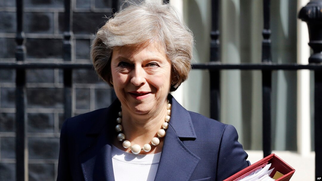 FILE- Britain's Prime Minister Theresa May leaves 10 Downing street in London, July 20, 2016. ﻿On her first visit to China as Britain’s prime minister, Theresa May will try to reassure Beijing that she wants to strengthen ties despite her delay on a decis