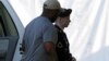 Army Pfc. Bradley Manning, right, is escorted into a courthouse in Fort Meade, Maryland, before a court martial hearing, July 18, 2013.