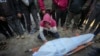A man mourns over the body of a Palestinian man killed during an Israeli army strike in Deir al-Balah in the central Gaza Strip, Jan. 2, 2025. 