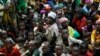 FILE - Refugees who fled Burundi's violence and political tensions wait to board a U.N. ship, at Kagunga on Lake Tanganyika, Tanzania, to be taken to the port city of Kigoma, May 23, 2015.