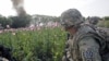 A U.S. Army Explosive Ordnance Disposal Technician from 5-20 infantry Regiment attached to 82nd Airborne looks at an intentional detonation of an explosive device in Zharay district in Kandahar province, southern Afghanistan, April 26, 2012. 