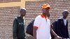 FILE - Rwandan singer Kizito Mihigo is escorted after his release from prison, in Kigali, Rwanda, Sept. 15, 2018.