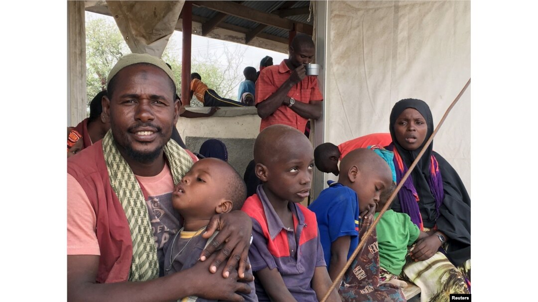 FILE - A Somali family waits to board a bus that will take them back home to Somalia from the Dadaab refugee camp in a voluntary repatriation programme, in Kenya, Jan. 21, 2016.