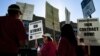 Public school teachers picket outside Amundsen High School in Chicago on the first day of a strike by the Chicago Teachers Union, Monday, Sept. 10, 2012.