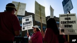 Public school teachers picket outside Amundsen High School in Chicago on the first day of a strike by the Chicago Teachers Union, Monday, Sept. 10, 2012.