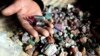 FILE - A Congolese mineral trader displays semi-precious tourmaline gem stones in a mud hut at Numbi in eastern Congo.