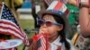 FILE - Eight year old Hana Cho from Girl Scout Troop 5665 tests out a horn prior to participating the 4th of July parade in Santa Monica, Calif. on Tuesday, July 4, 2017.