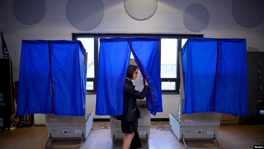 FILE - A voter leaves the booth after casting her ballot in the Pennsylvania primary at a polling place in Philadelphia, Pa., April 26, 2016.