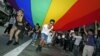 Participants hold a giant rainbow flag to symbolize lesbian, gay, bisexual, and transgender rights during a parade in Hong Kong, November 2011. (file photo)