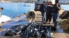 People check bodies of migrants that were drowned as they were trying to reach Greece, at a port near Izmir, Turkey, Jan. 21, 2016. 
