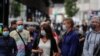 People wearing face masks to protect against the coronavirus queue to buy lottery tickets in downtown Madrid, Spain, Sept. 18, 2020. 