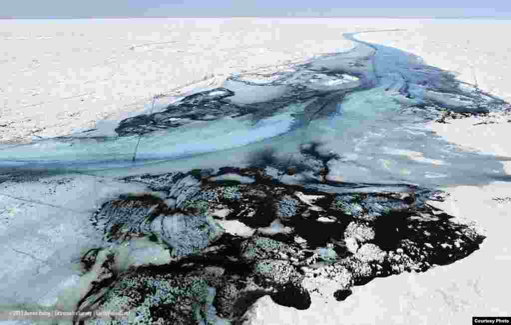 Greenland Ice Sheet melt water on the ice surface re-works windblown dust and soot into thick deposits. (James Balog/Extreme Ice Survey)