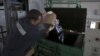 An employee throws sliced and packed meat into a furnace during the destruction of illegally imported food at a customs house at Pulkovo Airport in St. Petersburg, Russia, Aug. 6, 2015.