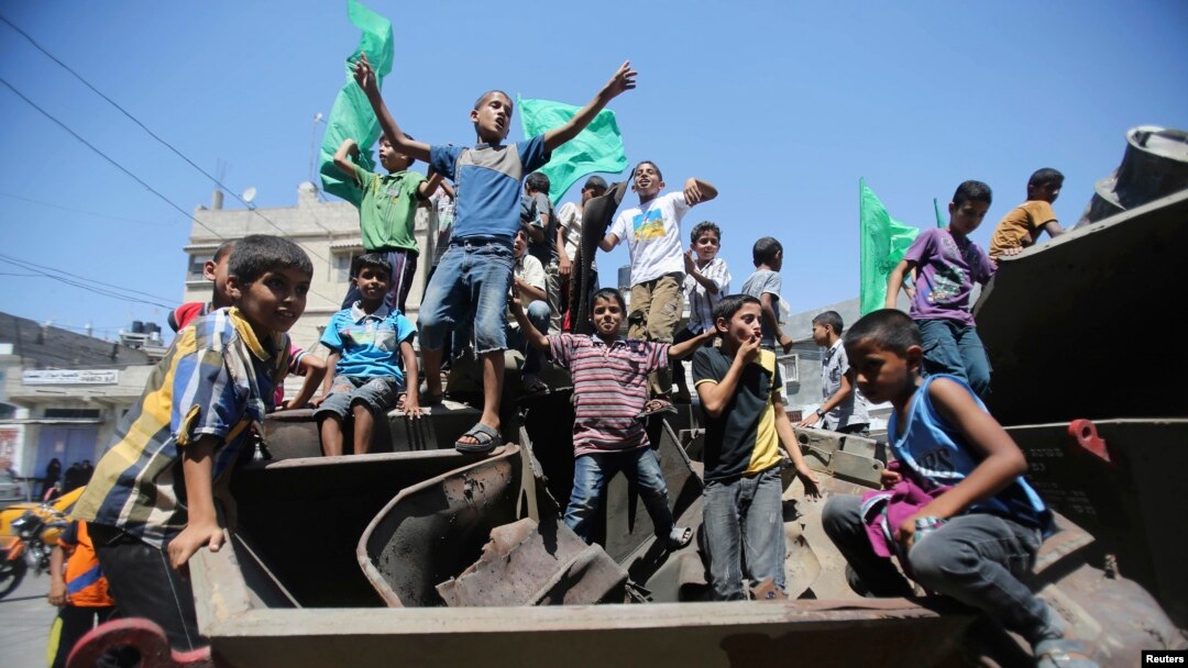 FILE - Palestinian children are seen waving Hamas flags in Khan Younis in the southern Gaza Strip.