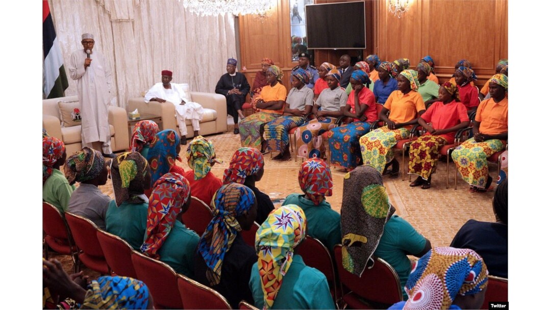 Nigerian President Muhammadu Buhari (left) addresses 82 freed Chibok schoolgirls during a meeting with them in Abuja, Nigeria, May 7, 2017. (Source - @MBuhari)