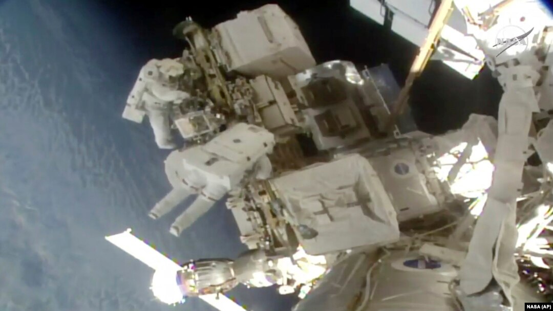 Astronauts Nick Hague and Christina Koch float outside the International Space Station, March 29, 2019, a week after the first spacewalk to install new and stronger batteries for the station’s solar power grid. 