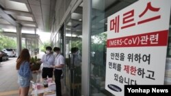 중동호흡기증후군(메르스) 감염자 발생으로 부분 폐쇄된 서울 일원동 삼성서울병원에서 23일 병원 관계자들이 출입자들의 체온을 점검하고 있다.