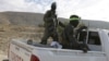 FILE - Fighters from the People's Protection Units (YPG), fighting alongside the Democratic Forces of Syria, ride on a pickup truck during what they said was an offensive against Islamic State militants to take control of Tishrin dam, south of Kobani, Syria Dec. 26, 2015.