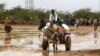 Newly arrived Somali refugees ride a donkey along the street at the Ifo Extension refugee camp in Dadaab, near the Kenya-Somalia border, October 19, 2011. 