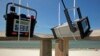 FILE - Air quality monitoring equipment is installed on the pier at the beach on Dauphin Island, Alabama, May 10, 2010, two days after tar balls washed up onshore. 