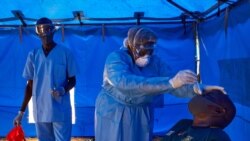 A member of South Sudanese Ministry of Health's Rapid Response Team take a sample from a man who has recently been in contact with a confirmed case of the COVID-19 coronavirus in Juba, South Sudan on April 13, 2020. - Four cases of the COVID-19…