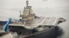 FILE - China's first aircraft carrier, which was renovated from an old aircraft carrier that China bought from Ukraine in 1998, is seen docked at Dalian Port, in Dalian, Liaoning province September 22, 2012. 