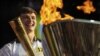 Torchbearer Tyler Rix smiles after lighting the Olympic Cauldron during the Olympic torch relay celebrations in Hyde Park, London, July 26, 2012. 