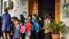 Children walk out of a building during the handover of orphaned children, whose parents were suspected of belonging to the Islamic State group, to a Russian delegation by Syrian Kurdish officials, in Syria's northeastern city of Qamishli, April 18, 2021.