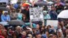 A person hold up a sign that reads "Fund Climate Change Research Saving The Planet Is Not a Waste of Money" during the March for Science in Washington, D.C., April 22, 2017.