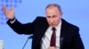 Russian President Vladimir Putin gestures as he speaks during his annual news conference in Moscow, Russia, Friday, Dec. 23, 2016.