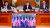 South Korean President Moon Jae-in looks at a TV broadcasting a news report on summit between the U.S. and North Korea during a cabinet meeting at the Presidential Blue House in Seoul, June 12, 2018. 