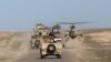 FILE - A convoy of Iraqi forces is seen moving through the Samarra desert, on the border between Anbar and Salahuddin provinces, Iraq, March 9, 2016.