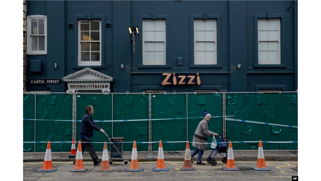 FILE - A police cordon and fence are placed outside a Zizzi restaurant near the area where former Russian double agent Sergei Skripal and his daughter were found critically ill following exposure to the Russian-developed nerve agent Novichok in Salisbury.
