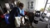 Kerrie Nocella pours seawater out of a bowl from her mother's china set as she helps salvage belongings from her parents' heavily damaged home in the aftermath of superstorm Sandy, Oct. 31, 2012, in Babylon Village, N.Y. 