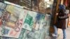 FILE - A woman enters a currency exchange shop in Tehran's business district, Oct. 24, 2011. 