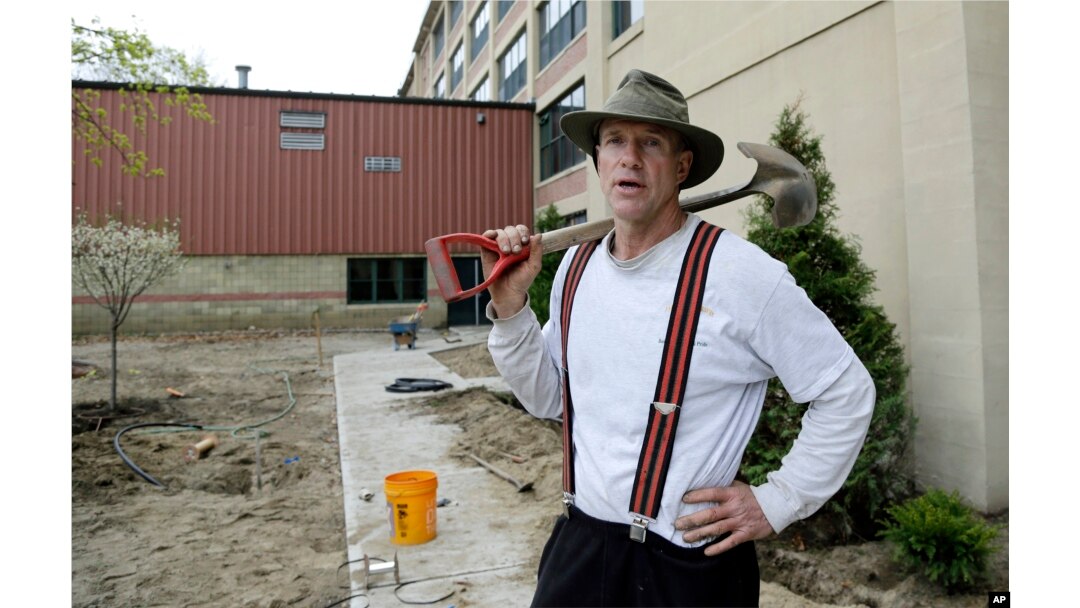 In this April 25, 2017 photo, Stephen Faulkner, owner of Faulkner's Landscaping & Nursery, works on a landscape project in Manchester, New Hampshire. Innkeepers, restaurateurs and landscapers around the U.S. say they’re struggling to find help.