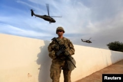 A U.S. Army soldier stands at a military base in the Makhmour area near Mosul, Iraq during an operation to attack to retake the city from IS militants on Oct. 18, 2016.