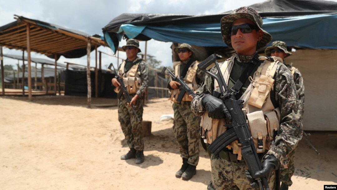 Peruvian military guard an illegal gold mining camp during a operation to destroy illegal machinery and equipment used by wildcat miners in Madre de Dios, Peru, March 5, 2019. 