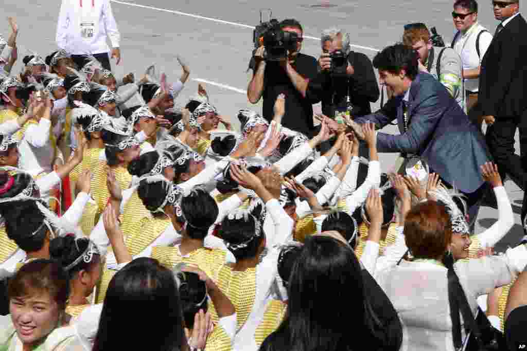 Canadian Prime Minister Justin Trudeau greets performers upon arrival at Clark International Airport in Clark, Pampanga province north of Manila, Philippines, Nov. 12, 2017.
