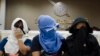 Unidentified Thai suspects of human trafficking appear at a news conference at police headquarters in Bangkok, Thailand, Aug. 4, 2015.