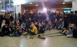 Journalists wait for Maria Butina's arrival, at Sheremetyevo International Airport outside Moscow, Russia, Oct. 26, 2019.