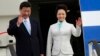 Chinese President Xi Jinping (L) and First Lady Peng Liyuan wave from their plane upon their arrival at Julius Nyerere International Airport in Dar es Salaam March 24, 2013. REUTERS/Thomas Mukoya 