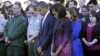 President Barack Obama, first lady Michelle Obama, and members of the White House staff observe a moment of silence to mark the 11th anniversary of the September 11, 2001 terrorist attacks on South Lawn of the White House.