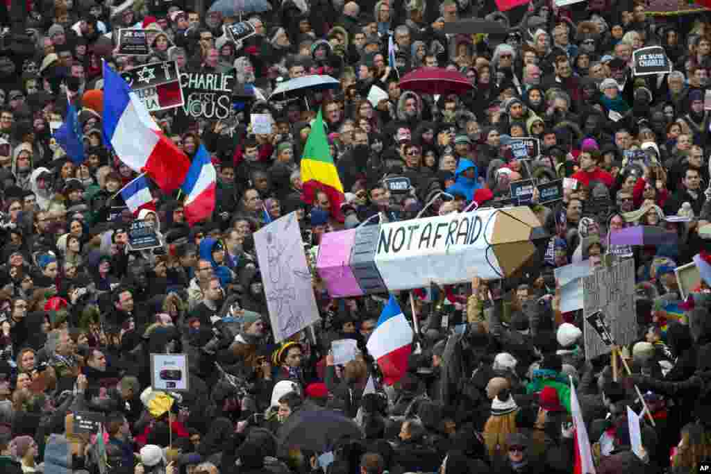 Thousands of people began filling France’s iconic Place de la Republique, Jan. 11, 2015, in a rally of defiance and sorrow to honor the 17 victims of three days of bloodshed that left France on alert for more violence.