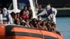 Migrants, picked up at sea, enter the port of Roccella Jonica, Calabria region, southern Italy, Nov. 14, 2021. 