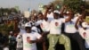 FILE -- Supporters of Edgar Lungu, leader of the Patriotic Front, celebrate after Lungu narrowly won re-election. The party of rival Hakainde Hichilema has since suspended a vice president.